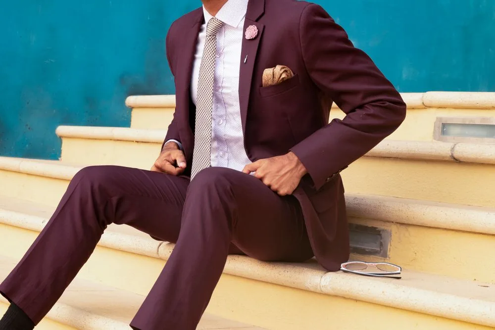 Burgundy suit styled with a patterned tie and pocket square